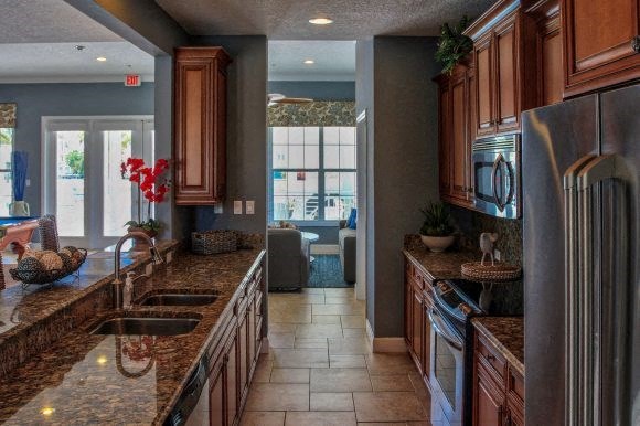 a kitchen with granite counter tops and stainless steel appliances