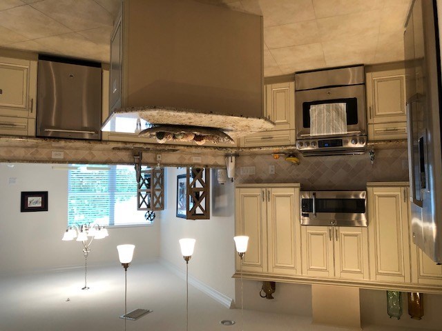 a kitchen with a stove top oven and a sink