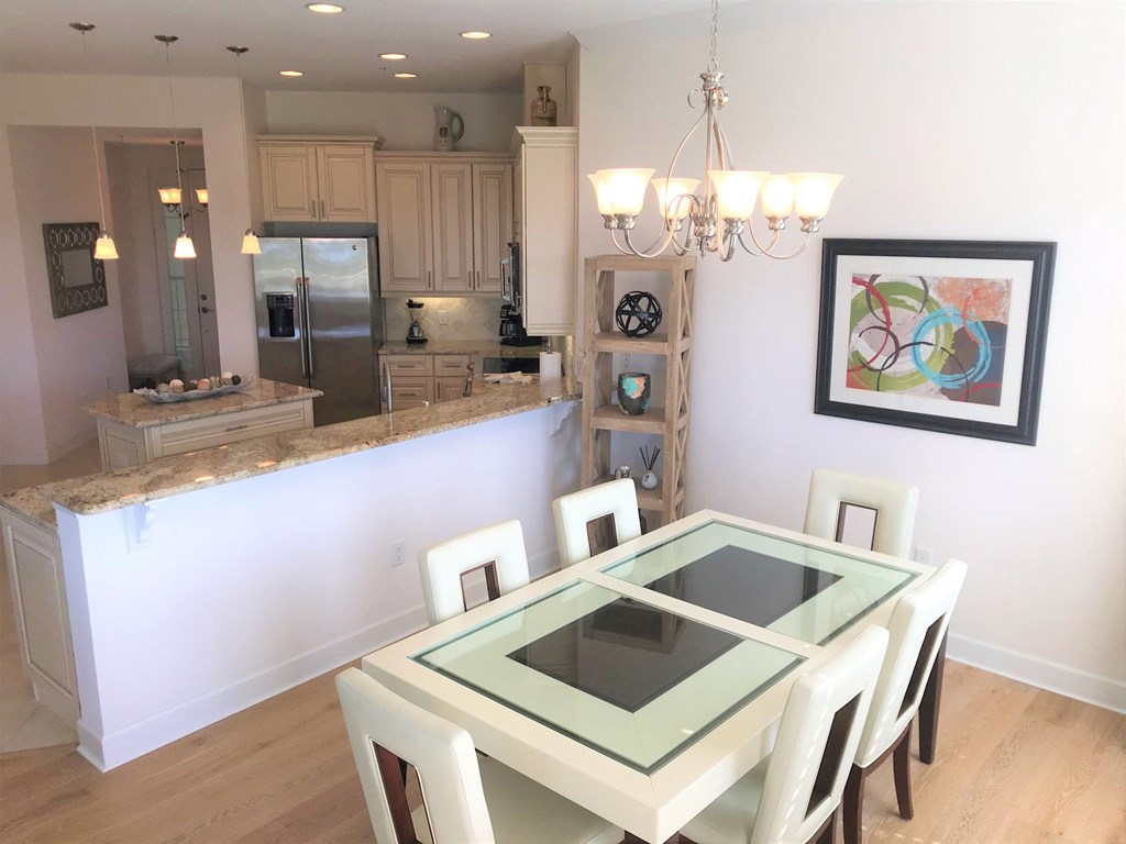 a dining room and kitchen with a table and chairs