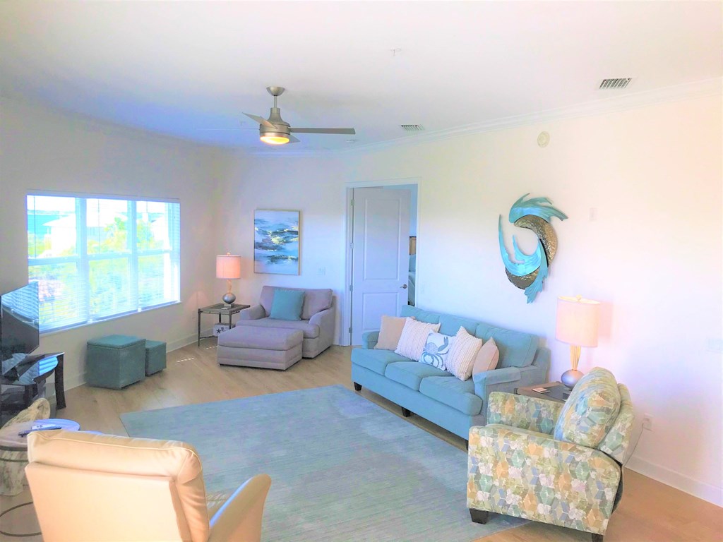 a living room with couches and chairs and a rug