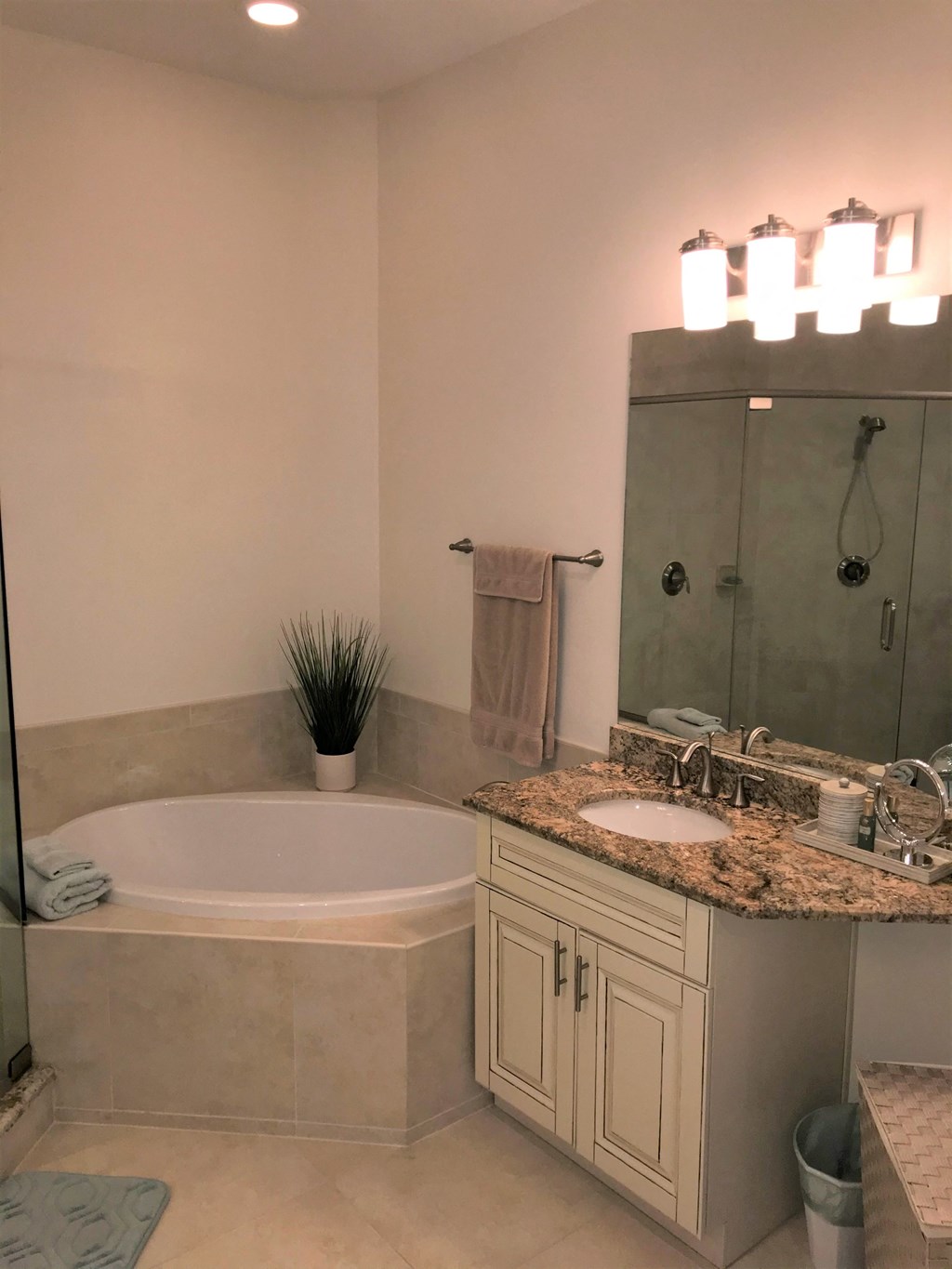a bathroom with a tub and a sink and a mirror