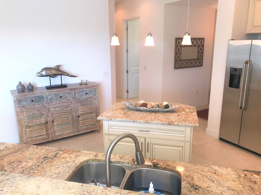 the kitchen has granite counter tops and stainless steel appliances