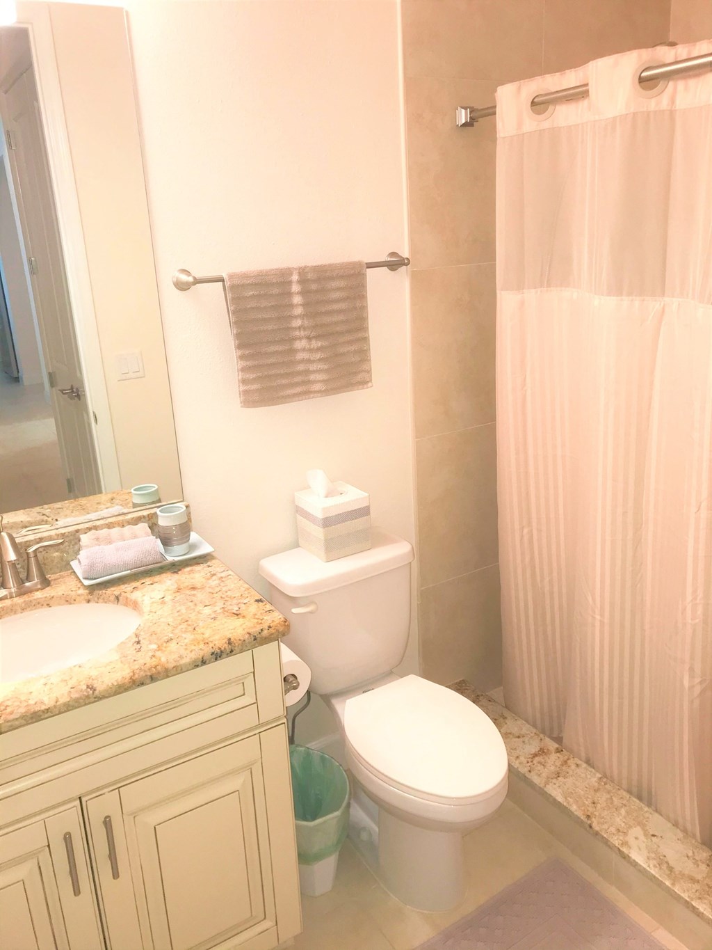 a bathroom with a toilet and a sink and a shower