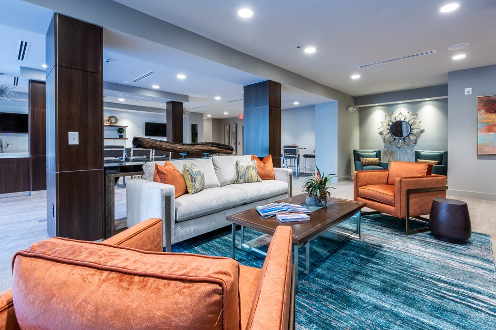 a living room with couches and chairs and a table