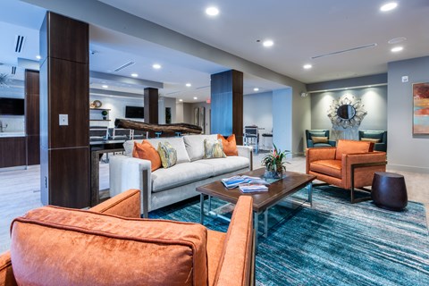 a living room with couches and chairs and a table