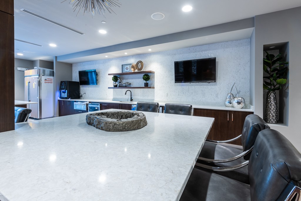 a large kitchen with a large white counter top