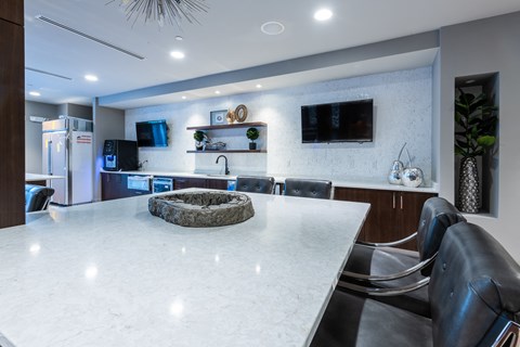 a large kitchen with a large white counter top