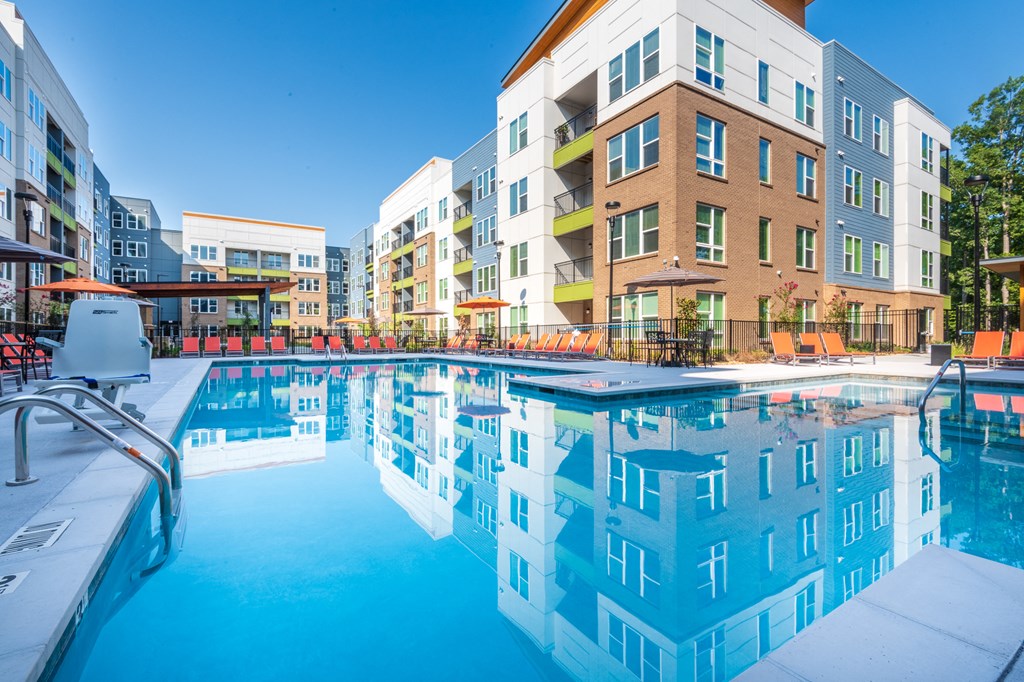 a swimming pool in front of an apartment building
