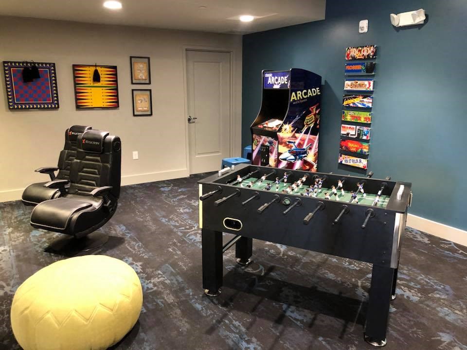 a game room with a foosball table and a chair