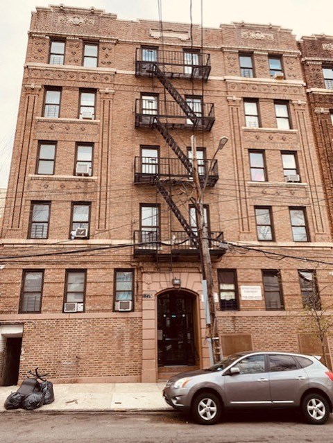 a car parked in front of a brick building