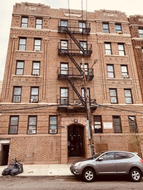 a car parked in front of a brick building