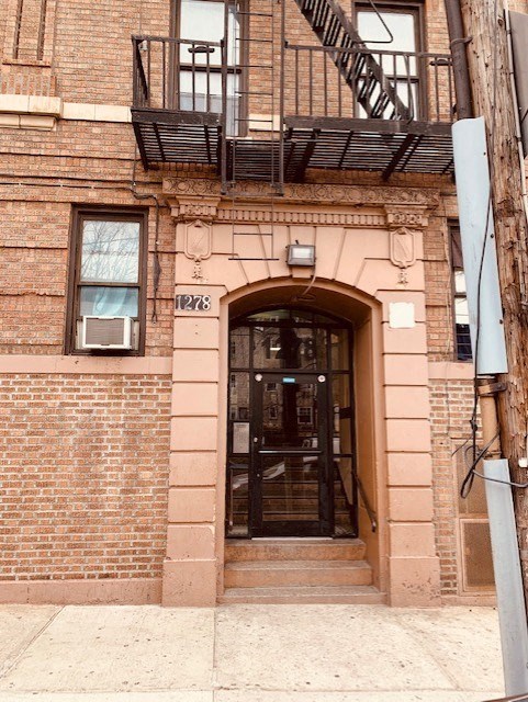 the front of a brick building with a glass door