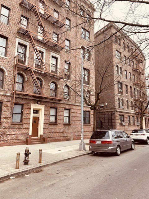 a car parked on a street in front of a brick building