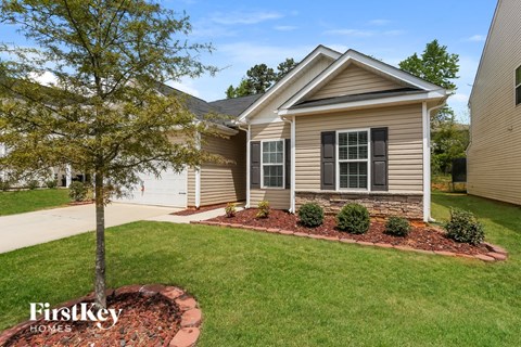 A house with a tree in front of it.