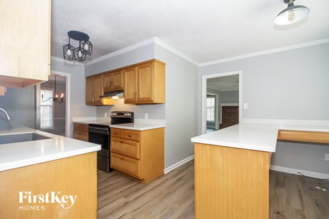 A kitchen with wooden cabinets and a white countertop.