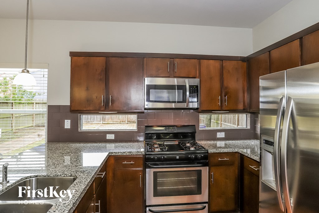 A kitchen with wooden cabinets and stainless steel appliances.