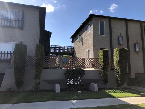 the front of a house with a bench in front of it
