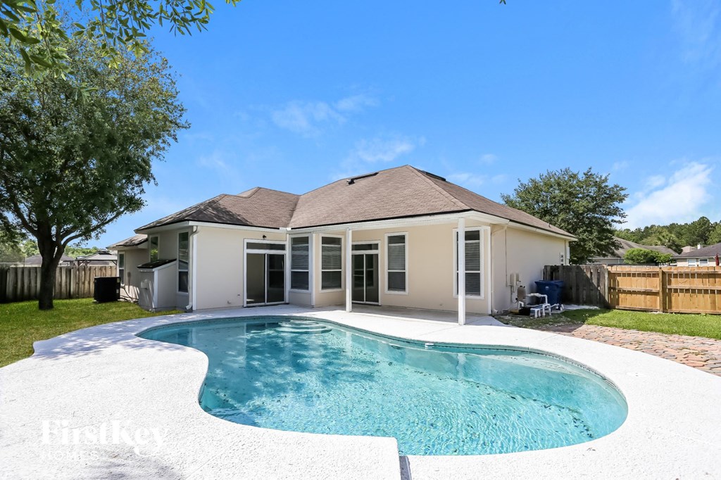 A house with a pool in the backyard.