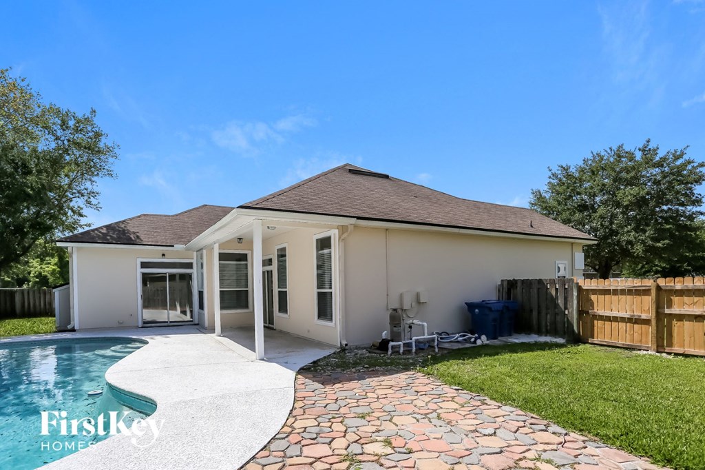 A house with a pool in the backyard.