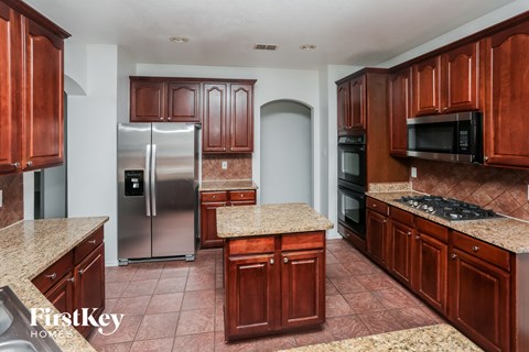 a kitchen with wooden cabinets and stainless steel appliances