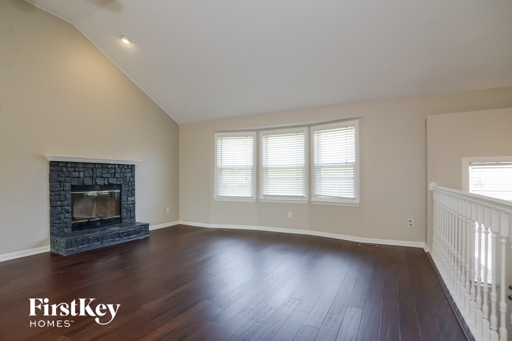 a living room with wood floors and a fireplace