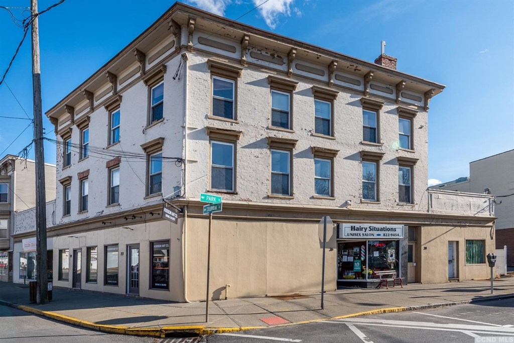 a large white building on the corner of a street
