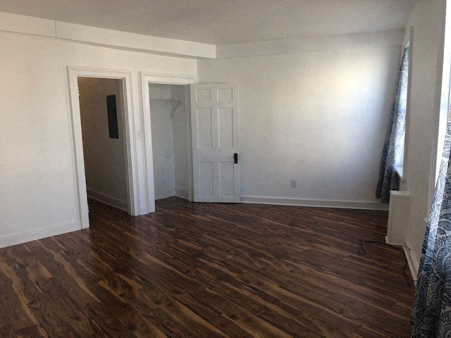 a empty room with a wooden floor and a door