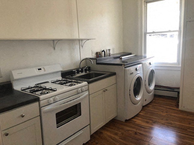 a kitchen with white appliances and a washing machine