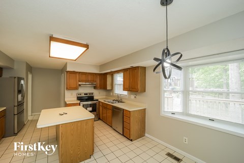 A kitchen with wooden cabinets and a white countertop.