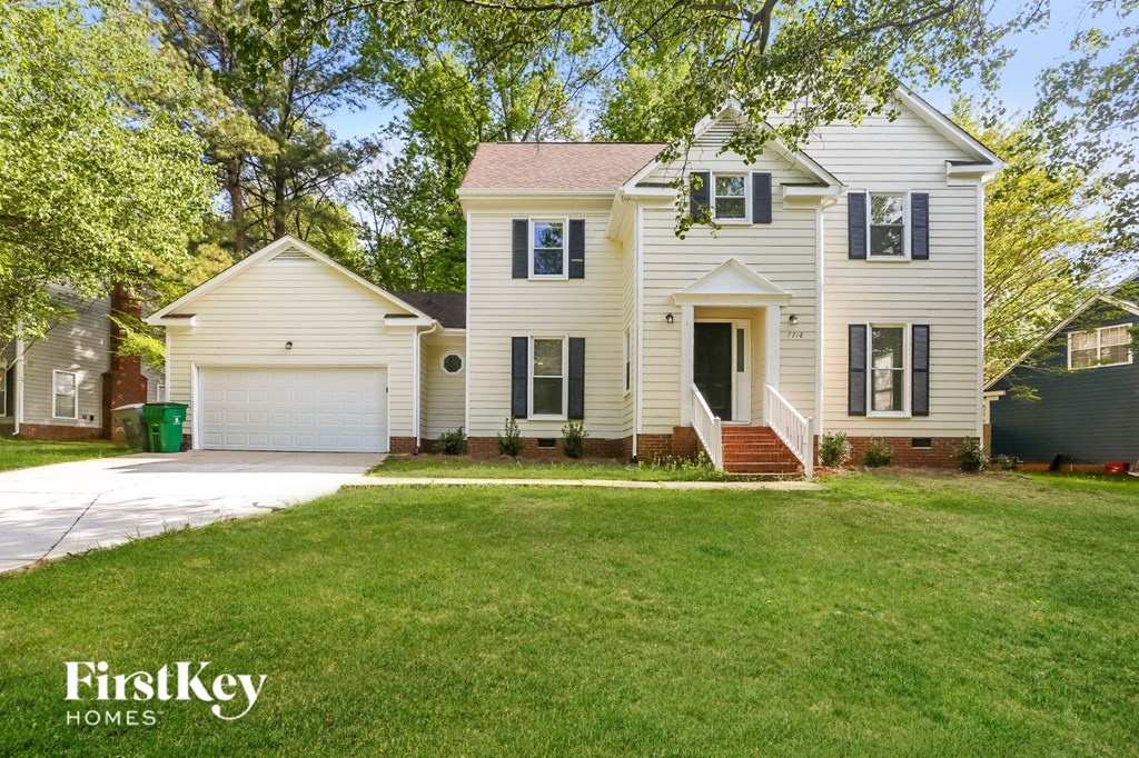 A white house with a garage is for sale by FirstKey Homes.