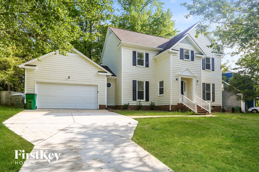 A two-story house with a garage is for sale.