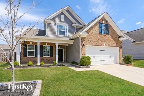 a house with a white garage door in front of a lawn
