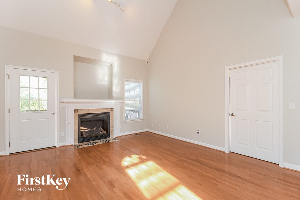 a living room with wood floors and a fireplace