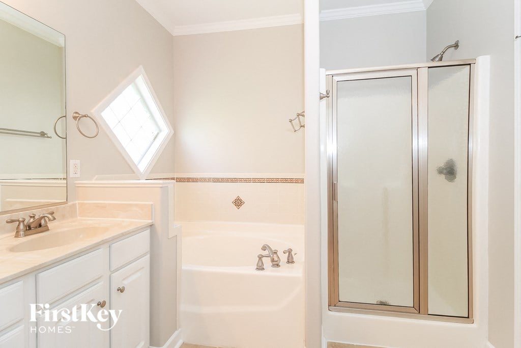 a bathroom with a shower and a sink and a mirror