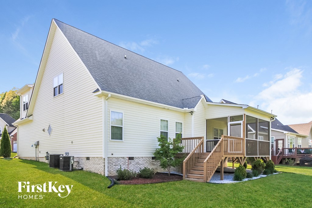 a white house with a porch and a deck