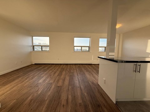 A room with wooden floors and white walls.
