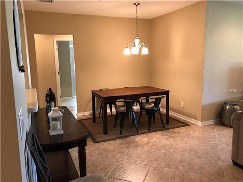 a dining room with a table and chairs
