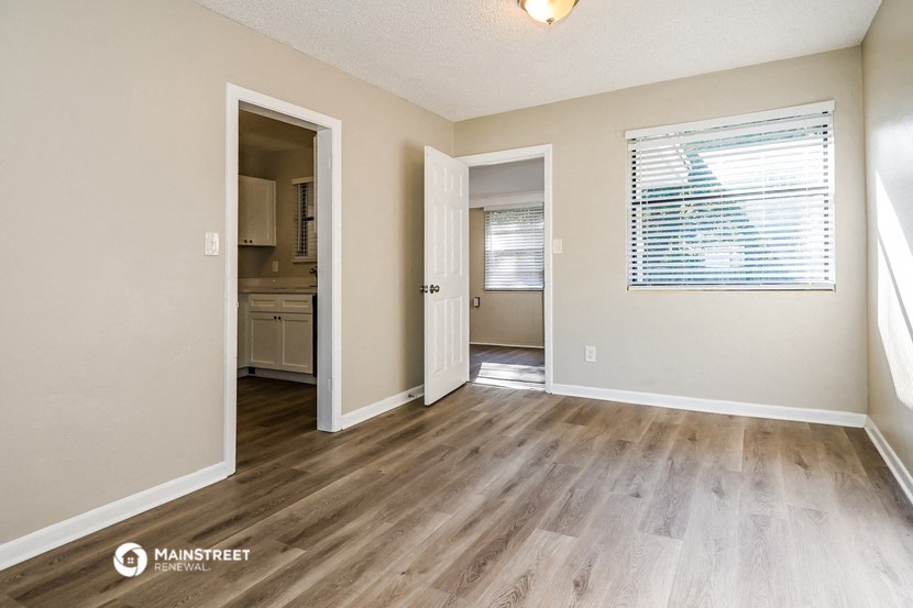 the spacious living room and dining room of an apartment