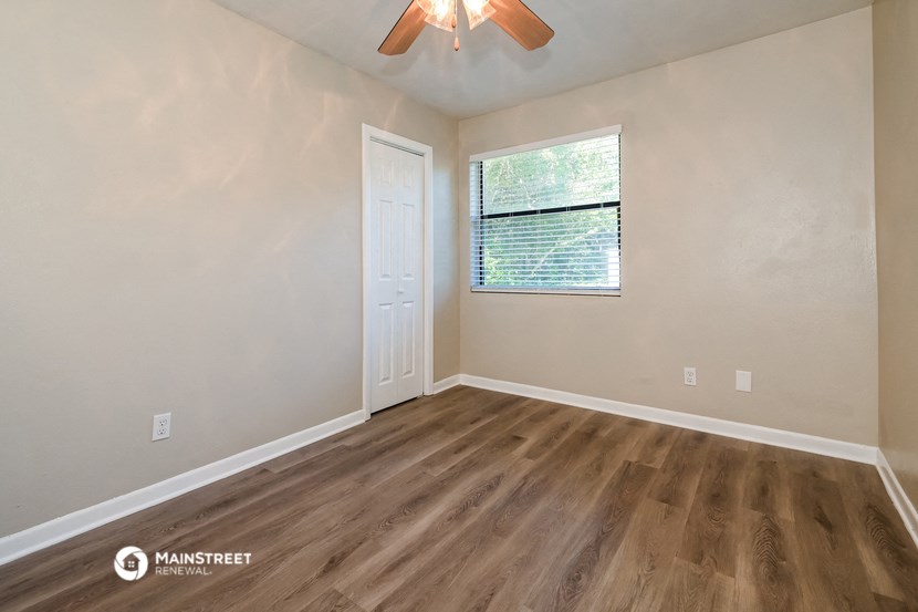 the bedroom of our studio apartment atrium with wood flooring and a window