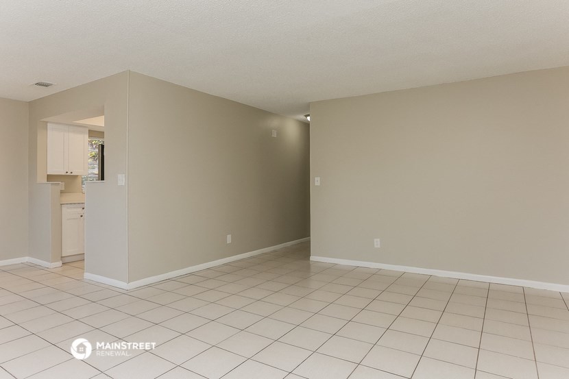 the living room and kitchen of an empty house