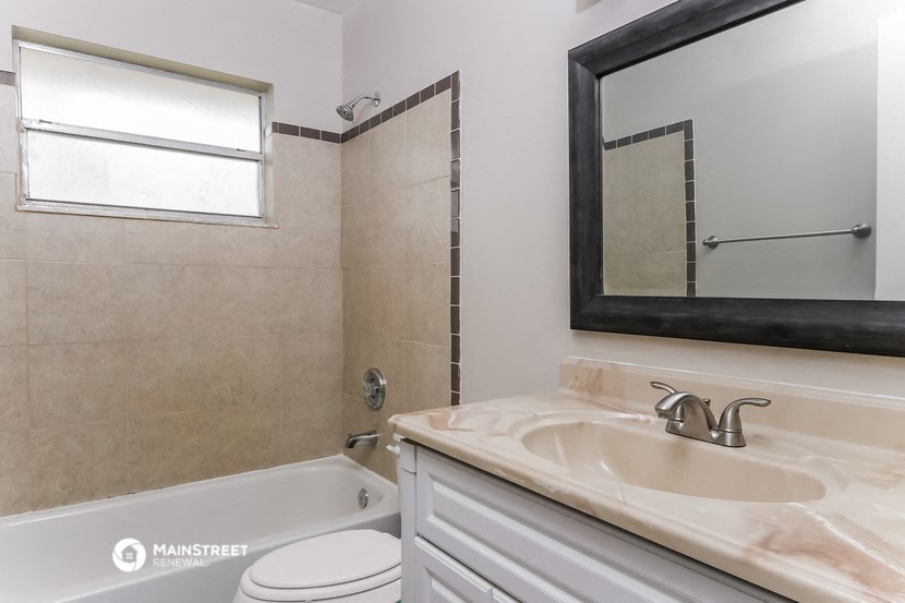a bathroom with a sink and a bath tub and a mirror