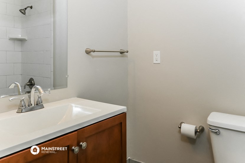 a bathroom with a sink and toilet and a mirror