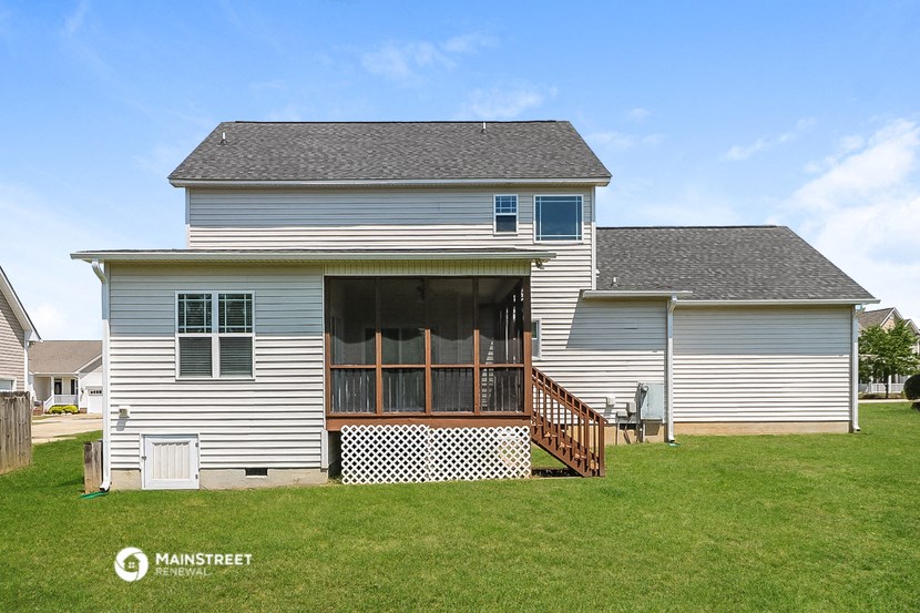 the front of a white house with a deck and a porch