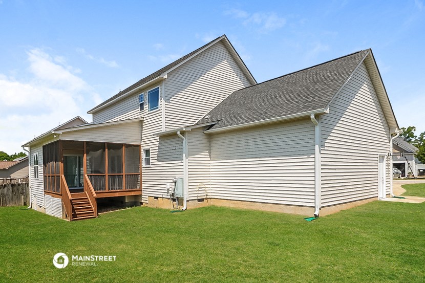 a view of the back of a house with a deck