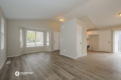 the living room and dining room of an apartment