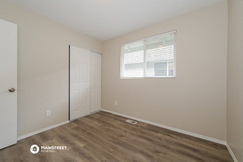 a bedroom with a door and a window