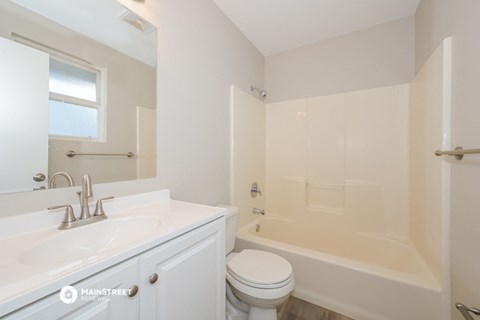 a bathroom with a sink and a toilet and a tub