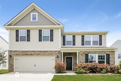 a house with a garage door in front of it