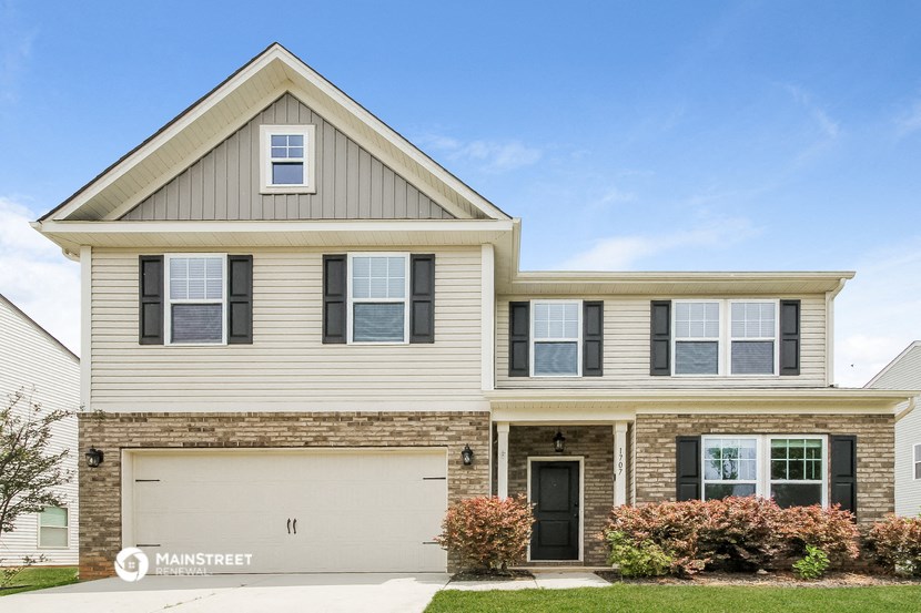 a house with a garage door in front of it