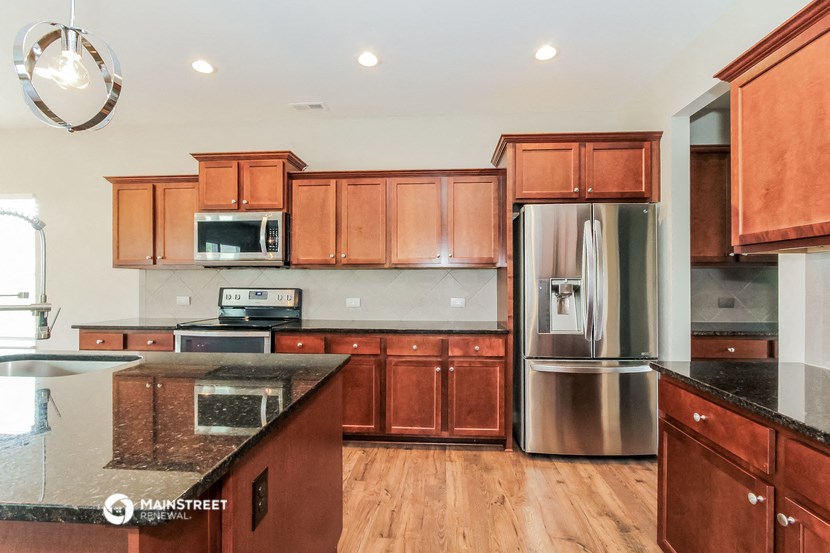 a kitchen with wooden cabinets and stainless steel appliances